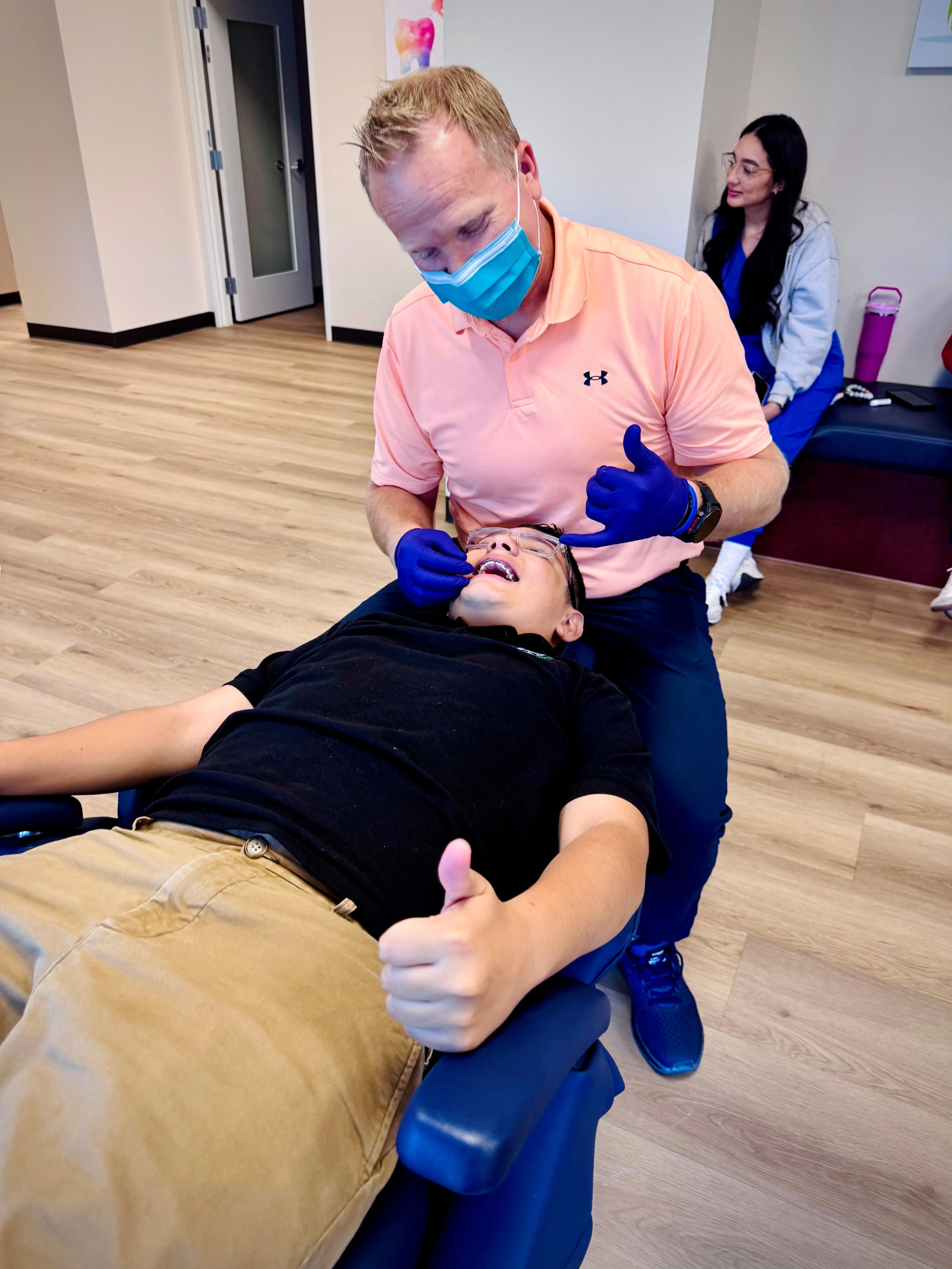 Orthodontist smiling with a young patient at Shadow Creek Children's Dentistry