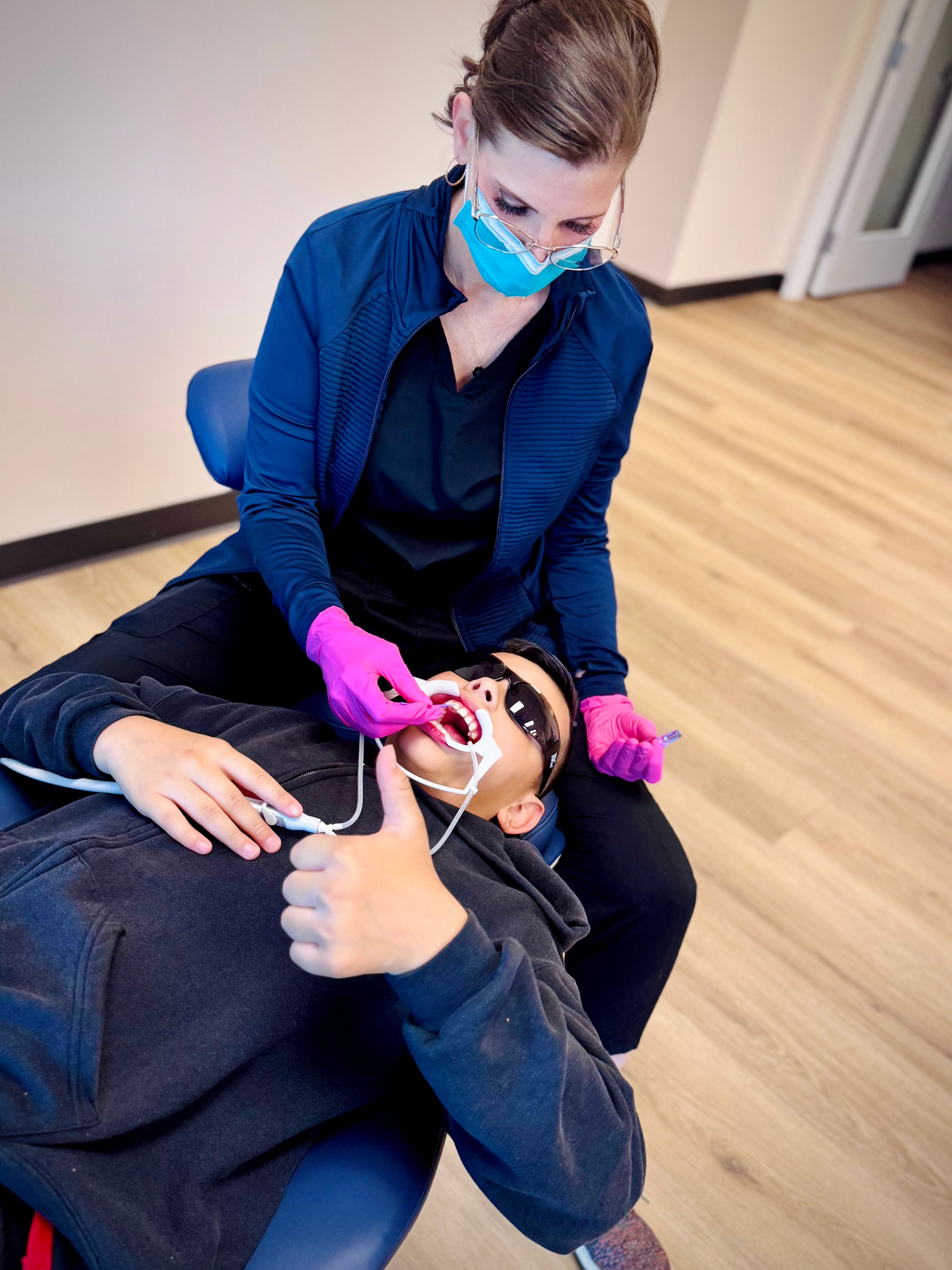 Pediatric dentist examining a young patient with care and precision